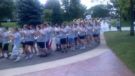 marching band leads the CLAS faculty toward their lunch